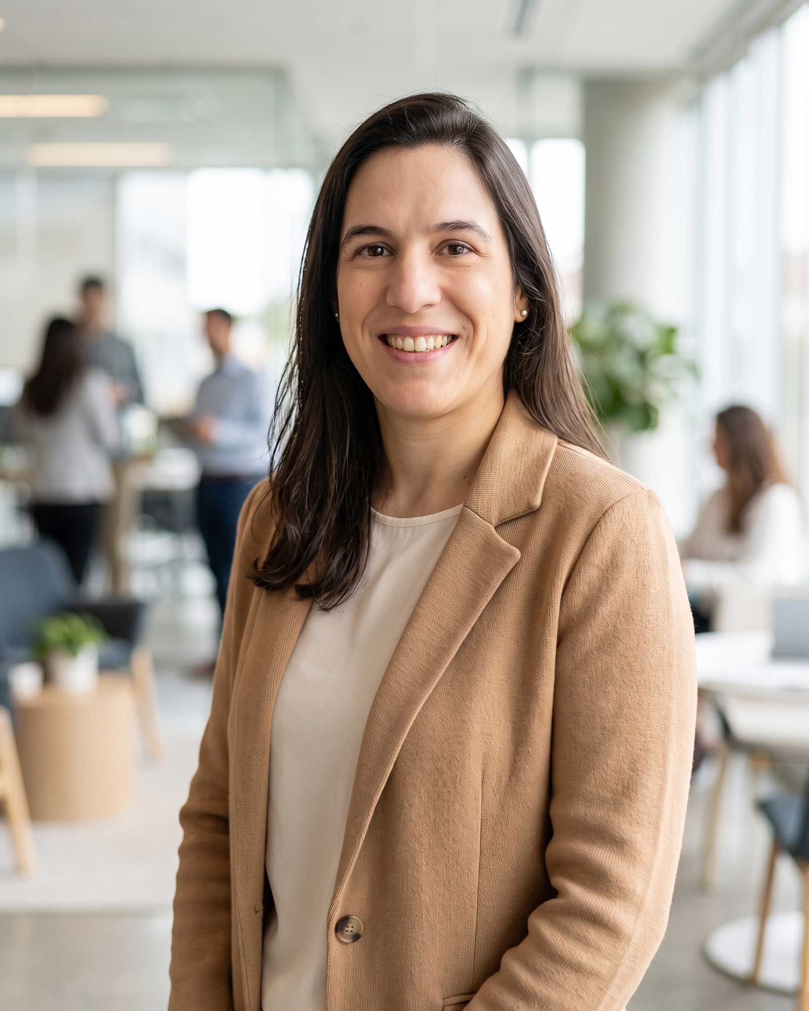 Rebeca Barrios, global HR and immigration operations leader, smiling in a modern office